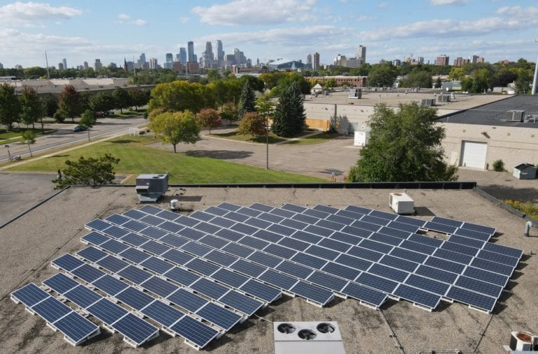 Aerial view of a small commercial solar array on a flat roof in Minneapolis, Minnesota