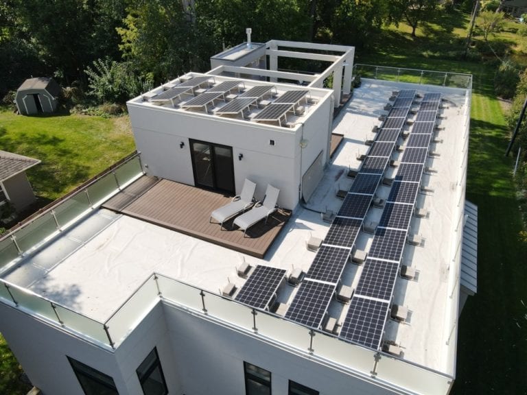 Tilted solar panels on a residential flat roof in Golden Valley, Minnesota.