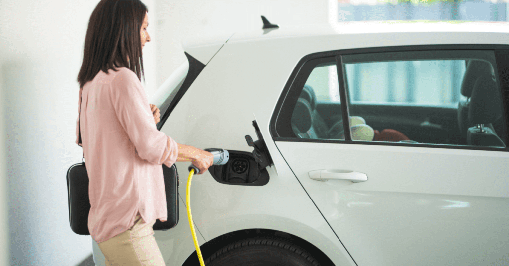 homeowner charging electric vehicle overnight in residential garage