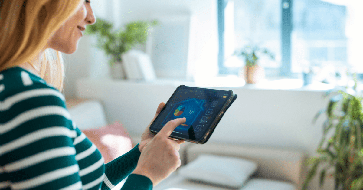 homeowner monitoring home energy usage on tablet connected to smart system