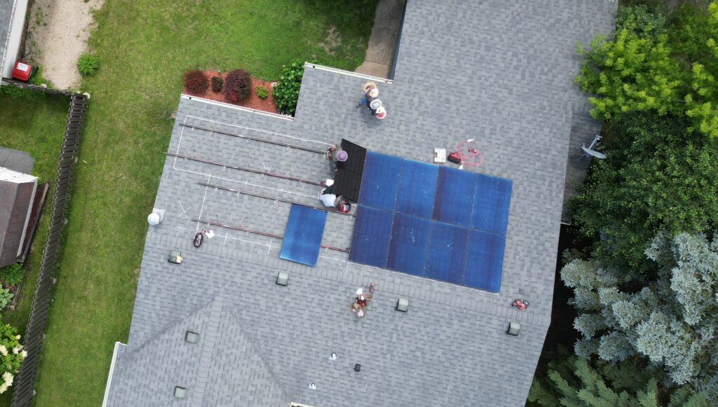 Powerfully Green energy specialist reviewing solar installation plan with Minneapolis homeowner