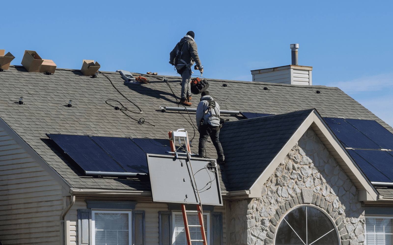 Solar technician removing panels from a Minneapolis home roof for a removal and reset project